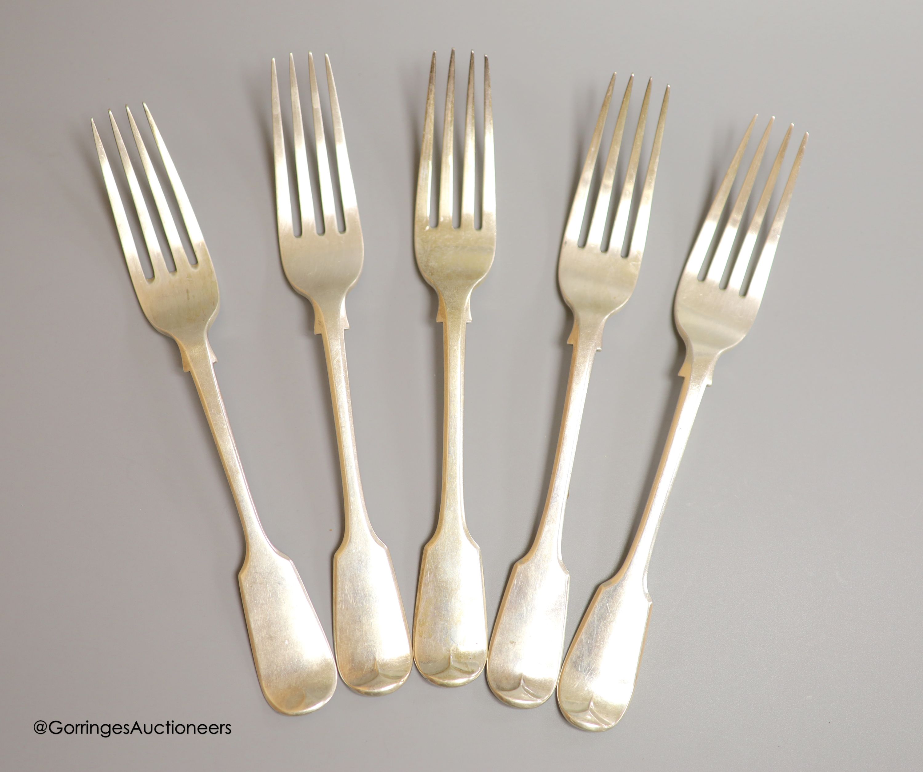 A set of five matched Victorian silver fiddle pattern table forks